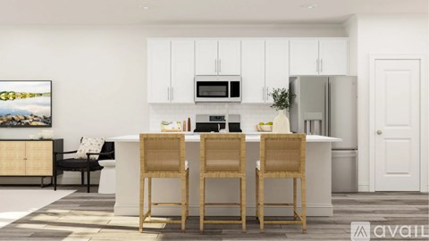 A kitchen with white cabinets and a white island with three chairs.