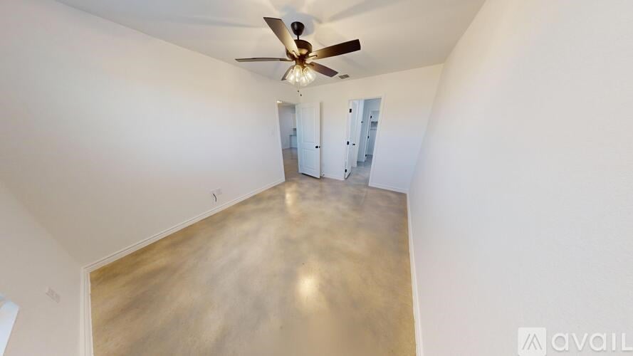 A kitchen with white cabinets and a black microwave.
