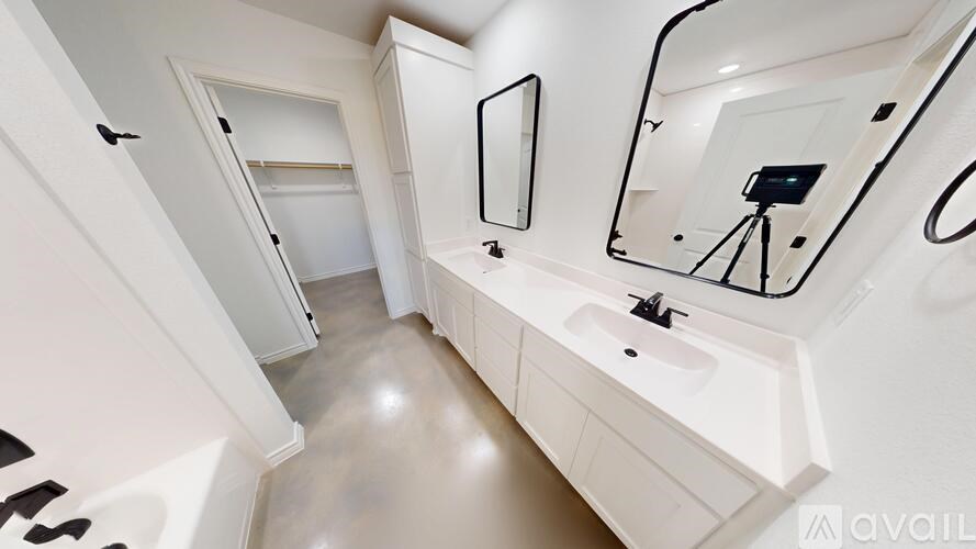 A kitchen with granite countertops and white cabinets.