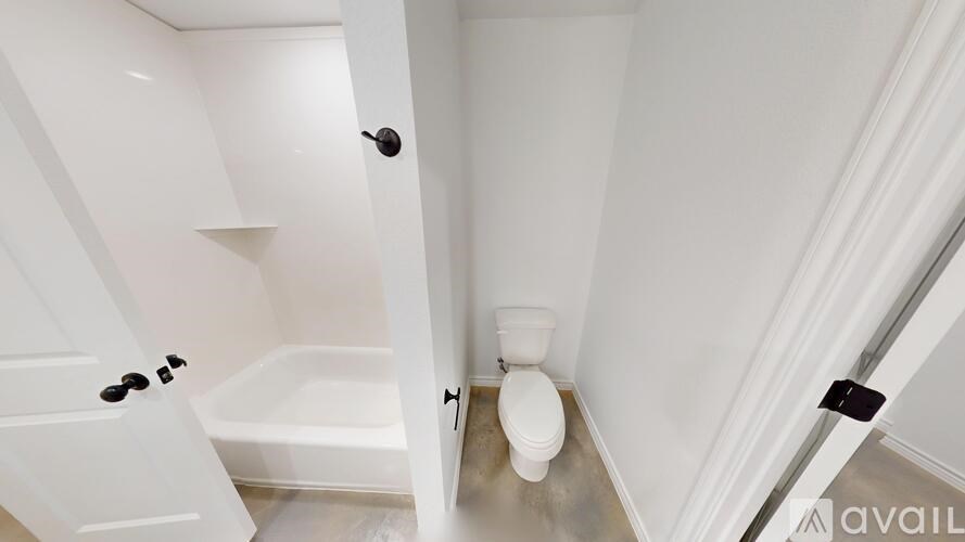 A spacious room with a ceiling fan and a window.