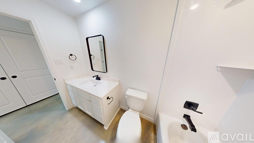 A room with a ceiling fan and two doors.