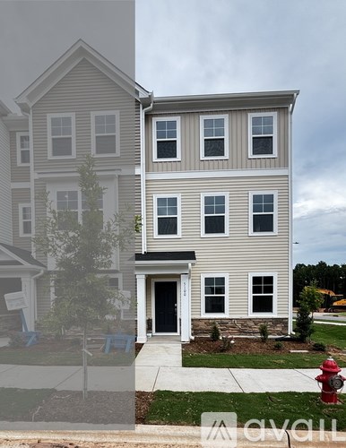 A two-story house with a red fire hydrant in front.