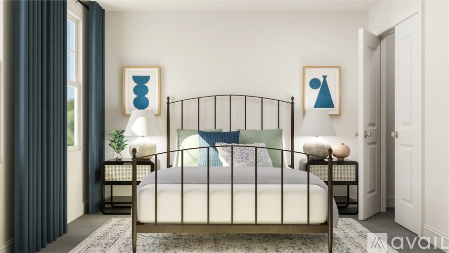 A bedroom with a large bed and two framed pictures on the wall.