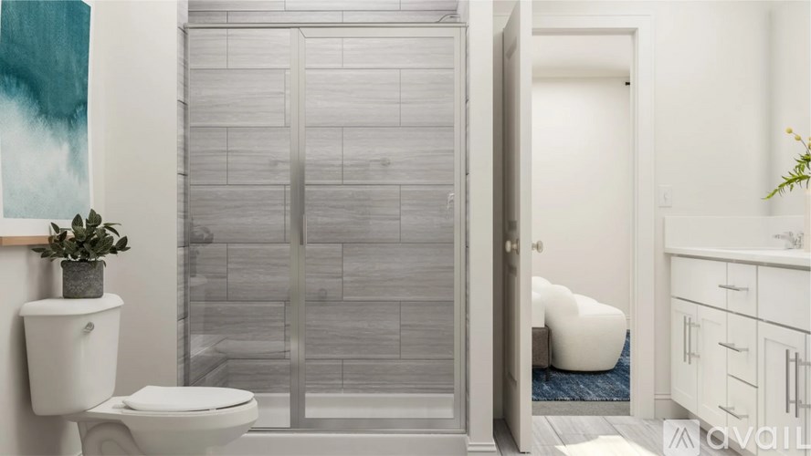A white toilet sits next to a glass door in a bathroom.