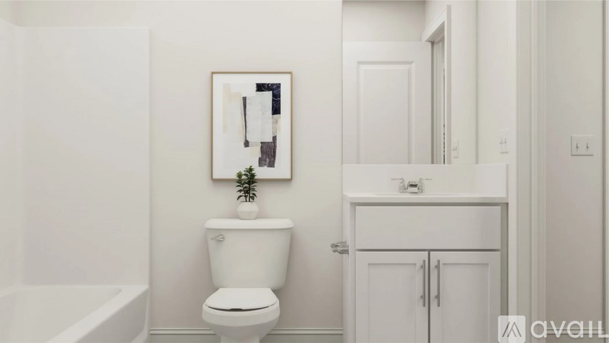 A white toilet sits in a bathroom next to a white bathtub.
