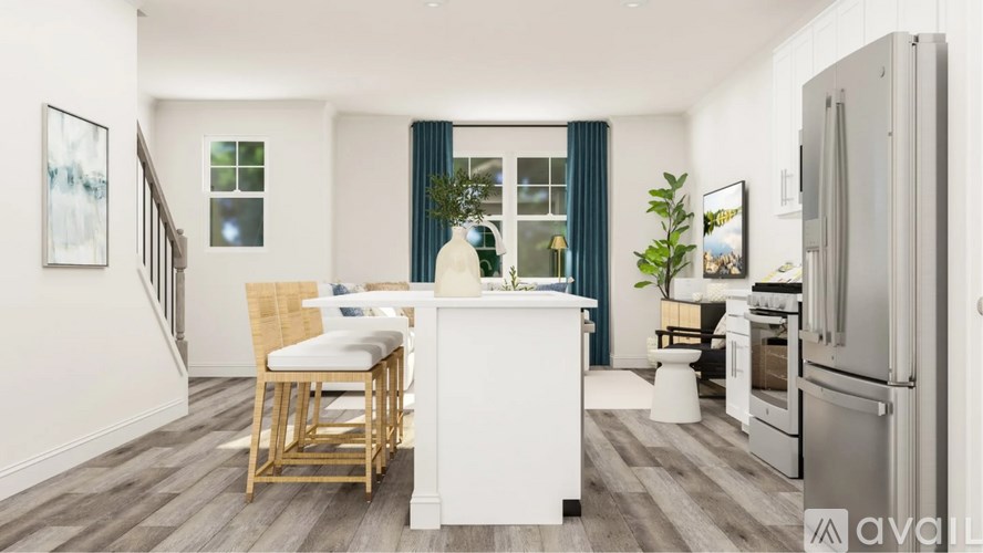 A kitchen with a white island and wooden chairs.