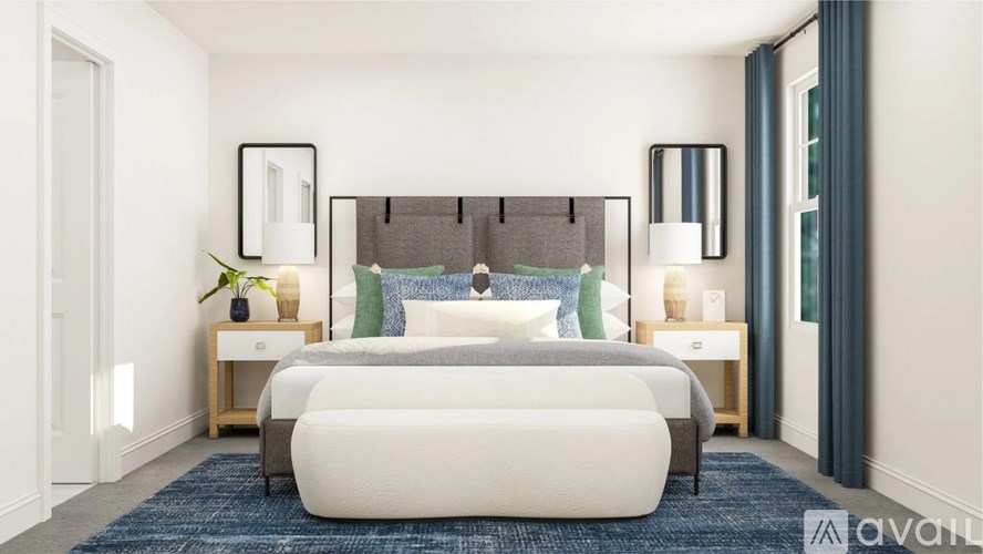 A bedroom with a large bed and two nightstands.