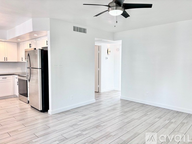 A modern kitchen with white appliances and cabinets.