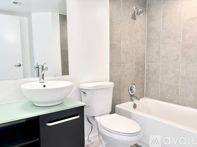 A white toilet sits next to a sink in a bathroom.