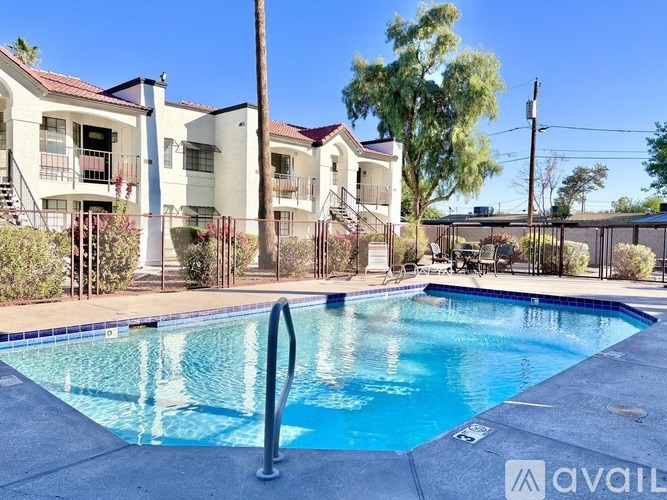 A swimming pool in front of apartment buildings.