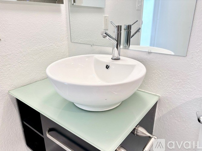 A white sink is on a green countertop.