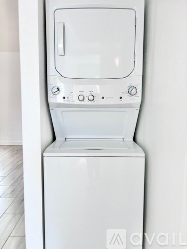 A white front loading washing machine with a glass door and control panel.