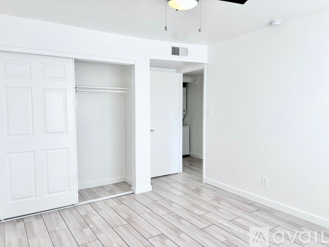 A white room with a door and a wall.