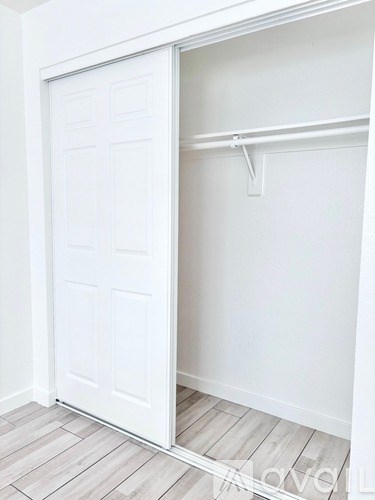 A white door is open to a white interior.