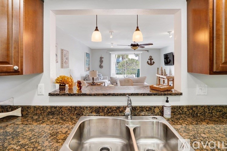 A kitchen with a sink and a window.