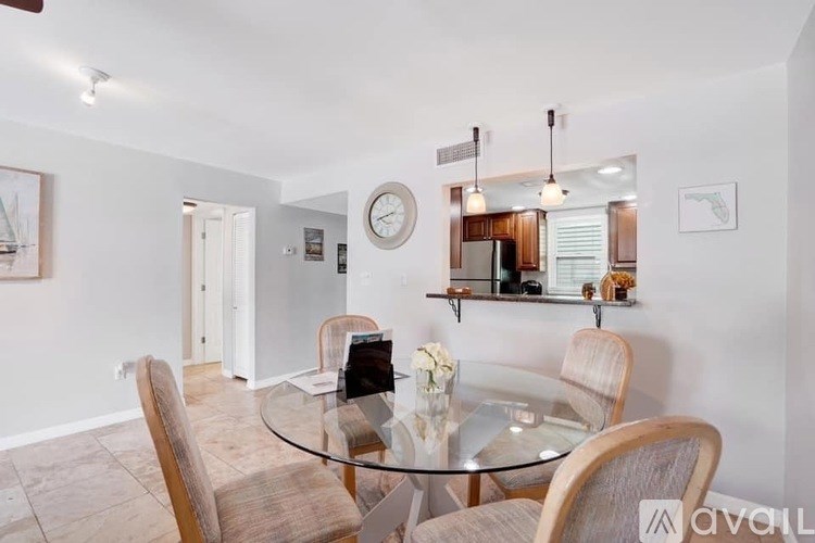 A dining room with a glass table and chairs.