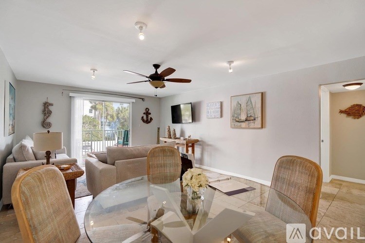 A living room with a glass table and chairs.