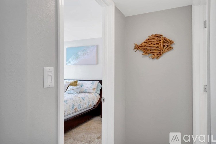 A room with a bed and a wall hanging.