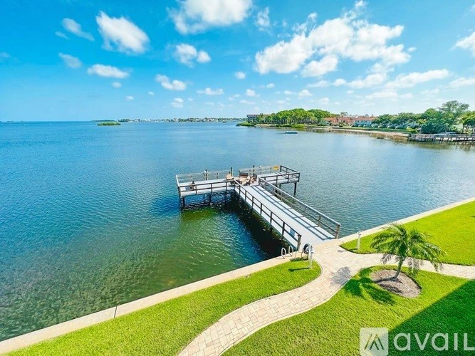 A dock extends into a calm body of water.