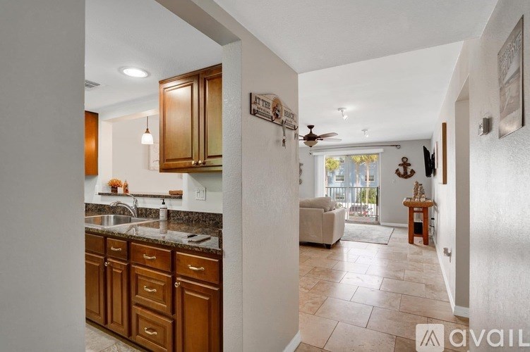 A kitchen with wooden cabinets and a countertop with a sink.