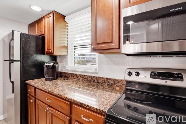 A kitchen with granite countertops and stainless steel appliances.