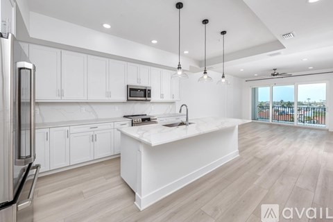 A modern kitchen with white cabinets and a central island.