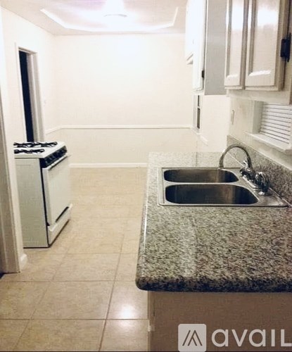 A kitchen with a granite countertop and a sink.