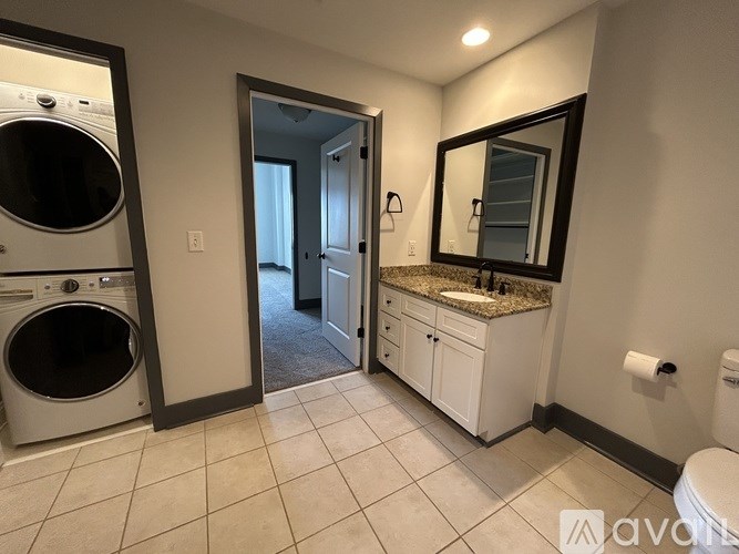 A bathroom with a washer and dryer in it.