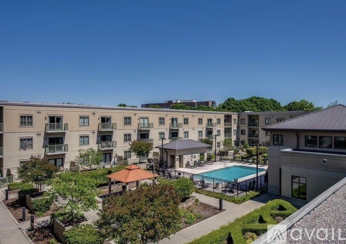 Apartment complex with a pool and a patio area.