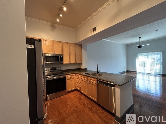 A kitchen with wooden cabinets and stainless steel appliances.