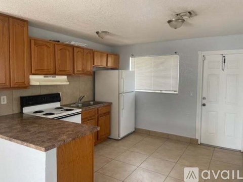 A kitchen with wooden cabinets and white appliances.