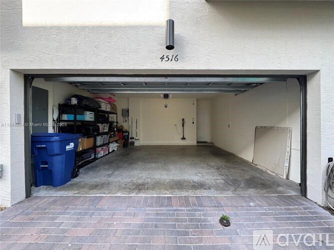 A garage with a brick floor and a number 4516 on the wall.