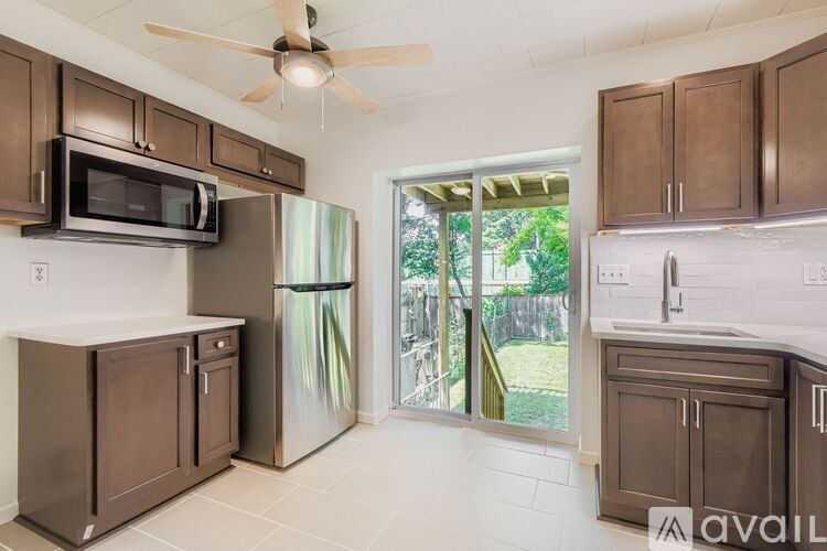 A kitchen with a refrigerator, oven, and cabinets.