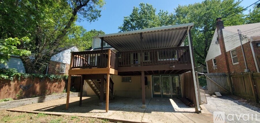 A wooden decked house with a metal roof is for sale.