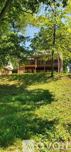 A house is surrounded by trees and grass.