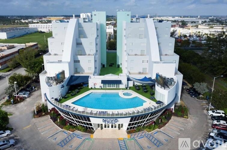 A modern white building with a pool in the middle.