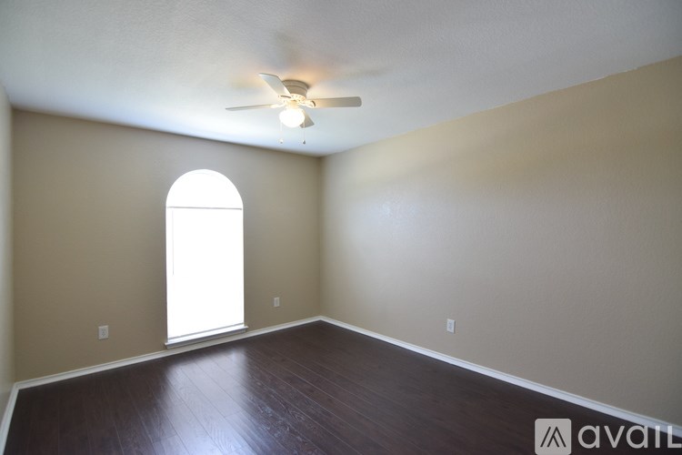 A kitchen with a white sink and black faucet.