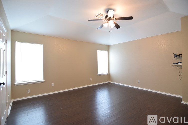 A kitchen with white cabinets and appliances.