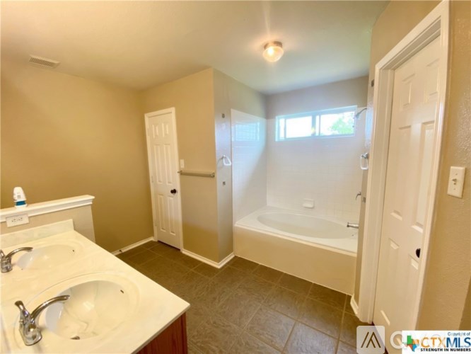 A bathroom with a sink, toilet, and bathtub.
