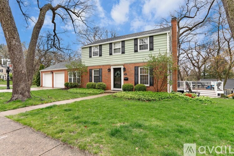 A house with a green exterior and a white door is for sale.