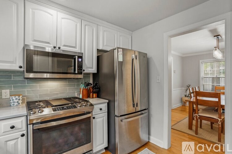 A kitchen with a stove, oven, refrigerator, and microwave.