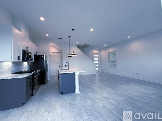 A modern kitchen with a large island in the middle.