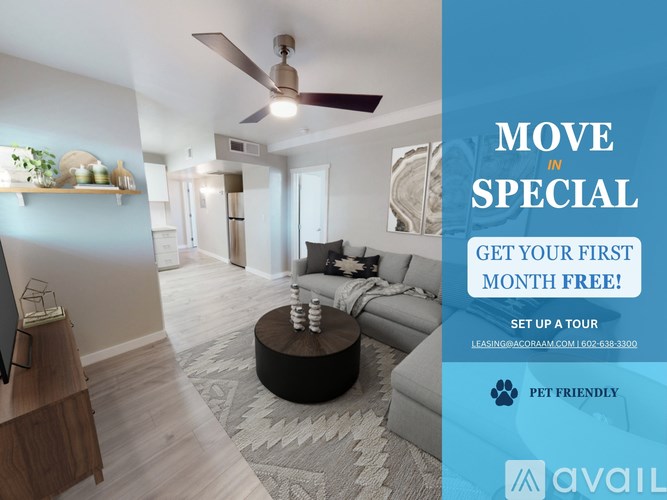 A room with a living area and a kitchen area with a sign advertising a free first month.