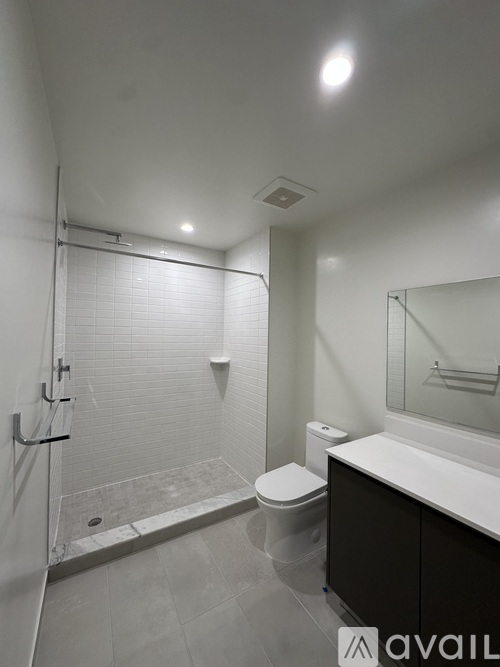 A bathroom with a toilet, sink, and shower.