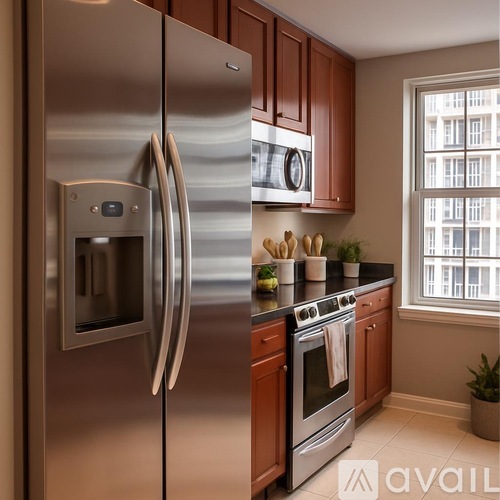 A modern kitchen with a stainless steel refrigerator and wooden cabinets.