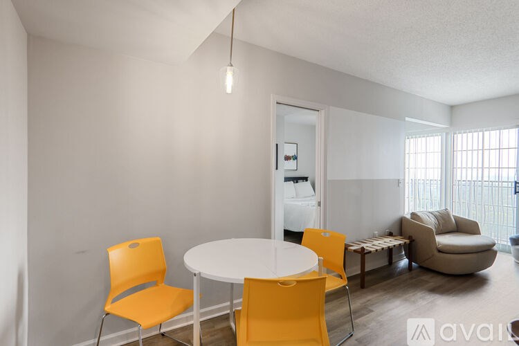 A white table with four chairs in a room.