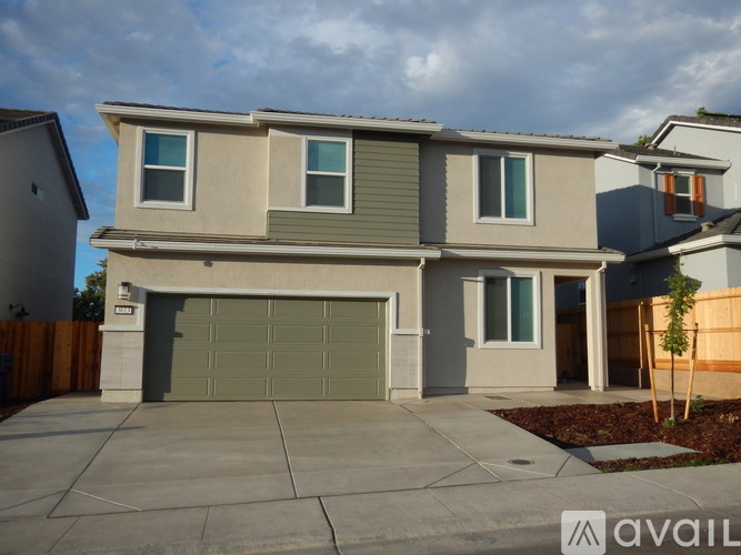 A two-story house with a garage is available for sale.