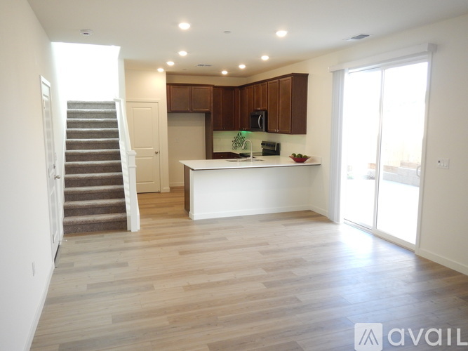 A spacious kitchen with wooden cabinets and a white island.