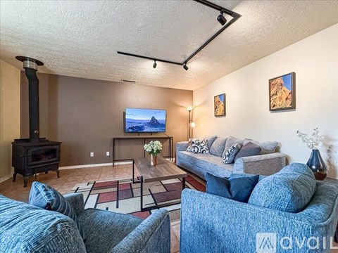 A living room with a blue couch and a television.