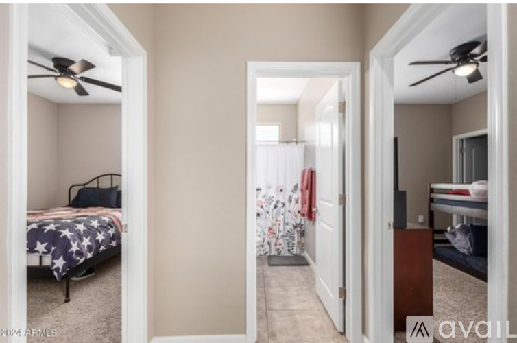 A bedroom with a bed and a fan.